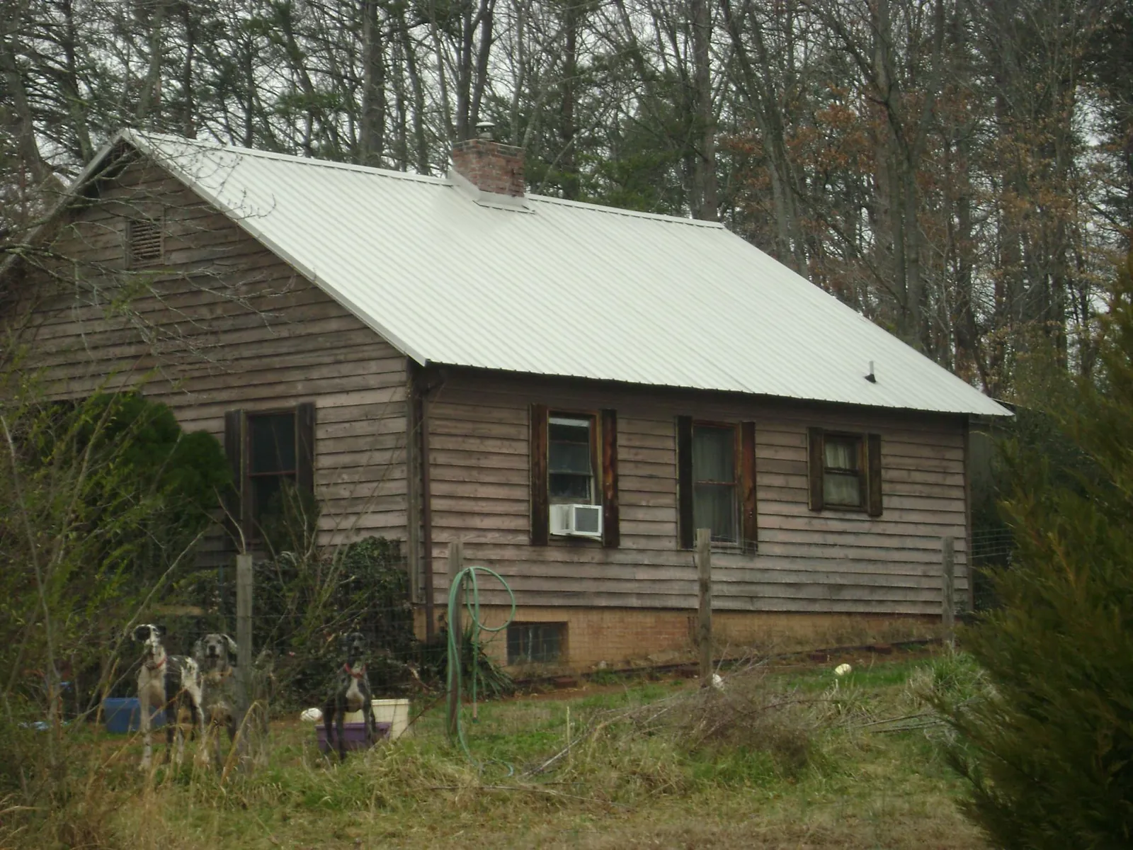 White metal roof on an old wood sided farmhouse, from a Metal Roof Installation job in Lagrange